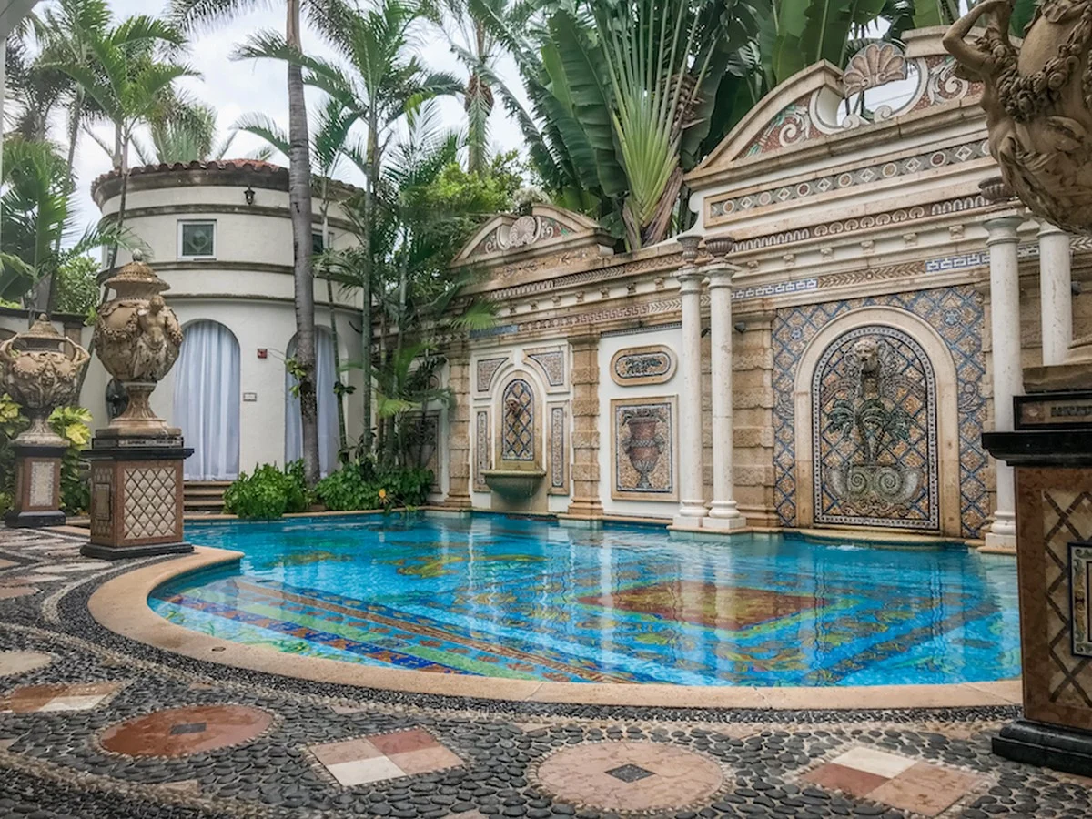 Balinese temple-inspired swimming pool with stone carvings