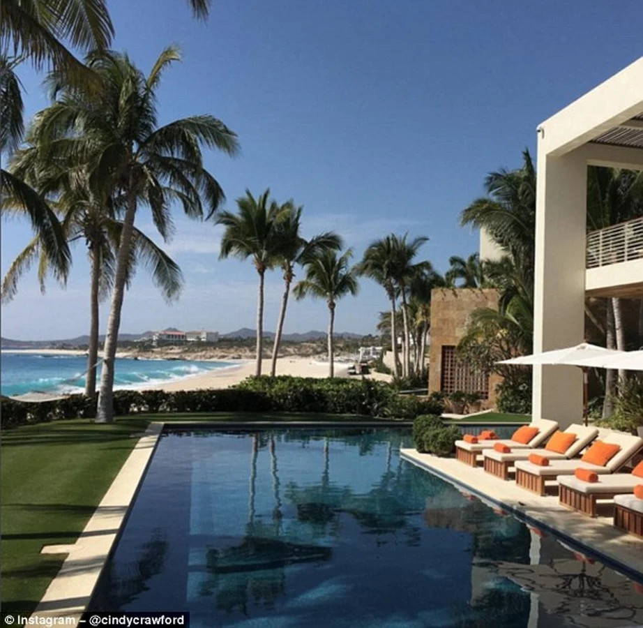 Tropical near-beach swimming pool with lush landscaping